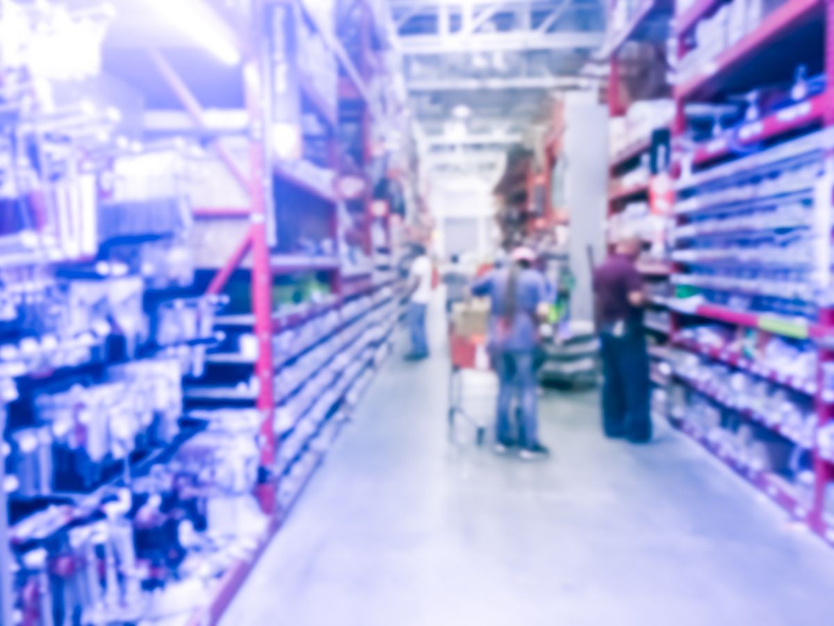Blurred abstract customer shopping for pipe fittings, tubing, valves, plumbing tools at hardware store in US. Pvc, polyethylene slip coupling, flow guard and worker restock the materials, goods